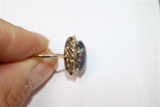 A yellow metal, opal and diamond oval cluster ring, size O.